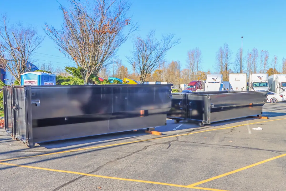 Professional dumpster rental service with roll-off container on residential driveway in St. Simons